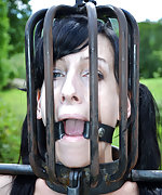 Cuffed, head caged, suspended upside down